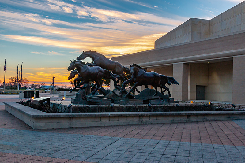 statue of horses at sunset